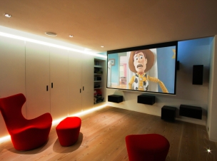 A JVC X-30 projector delivers crisp images on this hidden motorised 2.5m metre screen